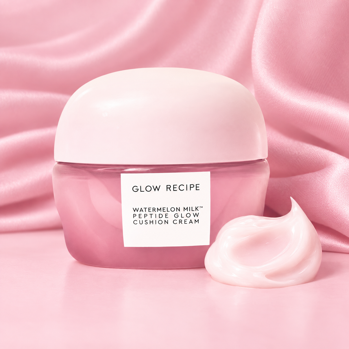 Glow Recipe Watermelon Milk Peptide Glow Cushion Cream jar beside a swirl of the cream